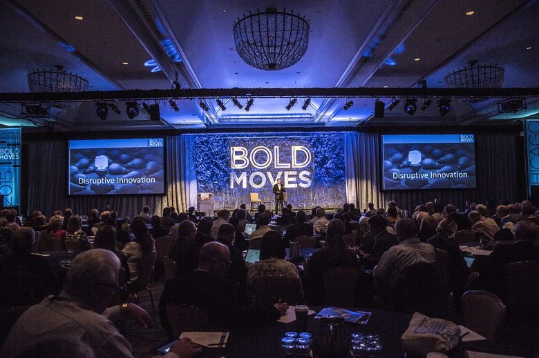 Nicholas Webb delivering a keynote to a large audience